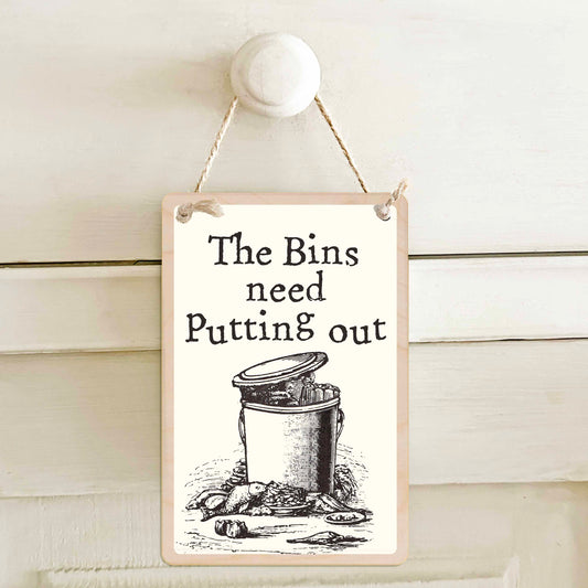 The bins are out / The bins need putting out - Double-sided wooden mini sign.
Made from certified sustainable wood and printed on both sides with a fun, practical message and retro illustration.
15 × 10 cm sustainable wood, natural twine.
Light and durable, eco-friendly, ready to hang.
Made in Suffolk.