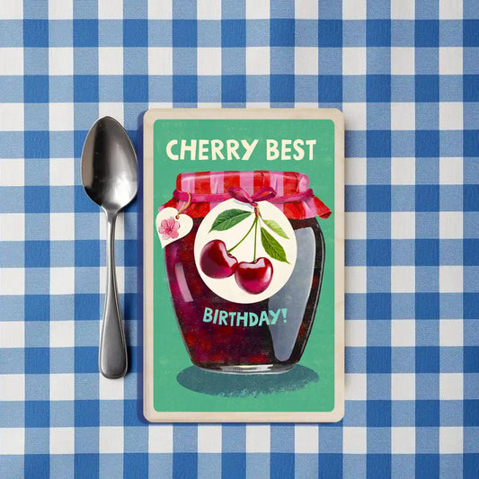 Birthday Card: Jar of cherry jam with a birthday message on a green background. The Wooden Postcard Company
