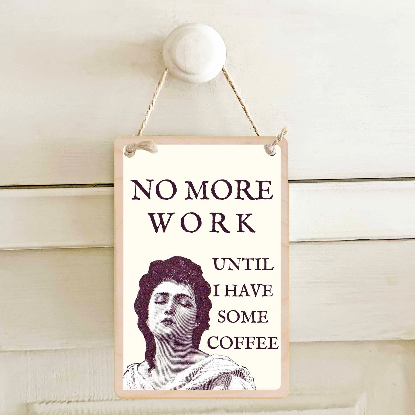 Sign with a classical woman's portrait and 'No more work until I have some coffee'. The wooden postcard company