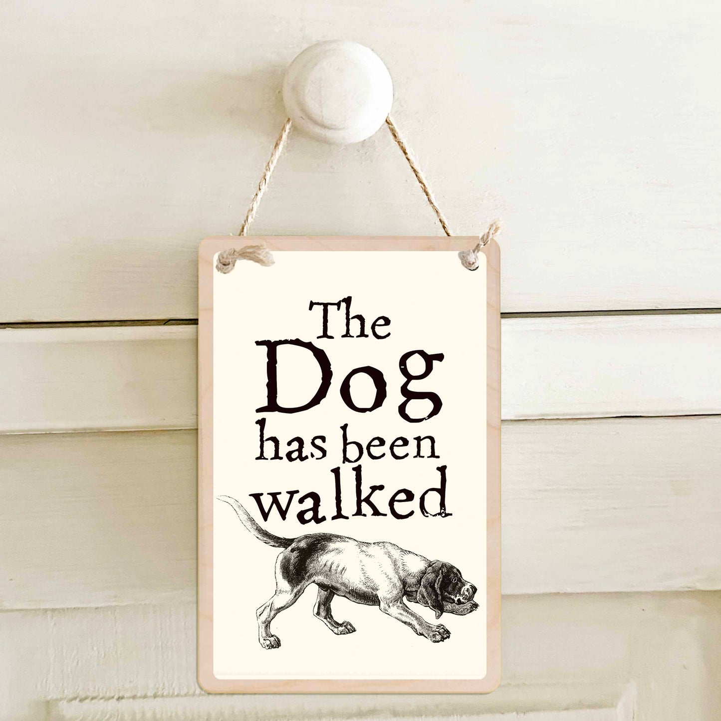 The Dog has been walked / The Dog has not been walked - Double-sided wooden mini sign.

Made from certified sustainable wood and printed on both sides with a fun, practical message and retro illustration.

15 × 10 cm sustainable wood, natural twine.

Light and durable, eco-friendly, ready to hang.

Made in Suffolk.