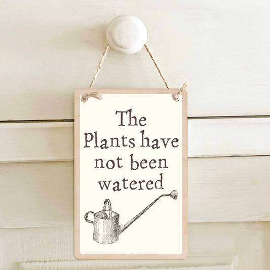 The plants have been watered / The plants have not been watered - Double-sided wooden mini sign.

Made from certified sustainable wood and printed on both sides with a fun, practical message and retro illustration.

15 × 10 cm sustainable wood, natural twine.&nbsp;

Light and durable, eco-friendly, ready to hang.

Made in Suffolk.&nbsp;
