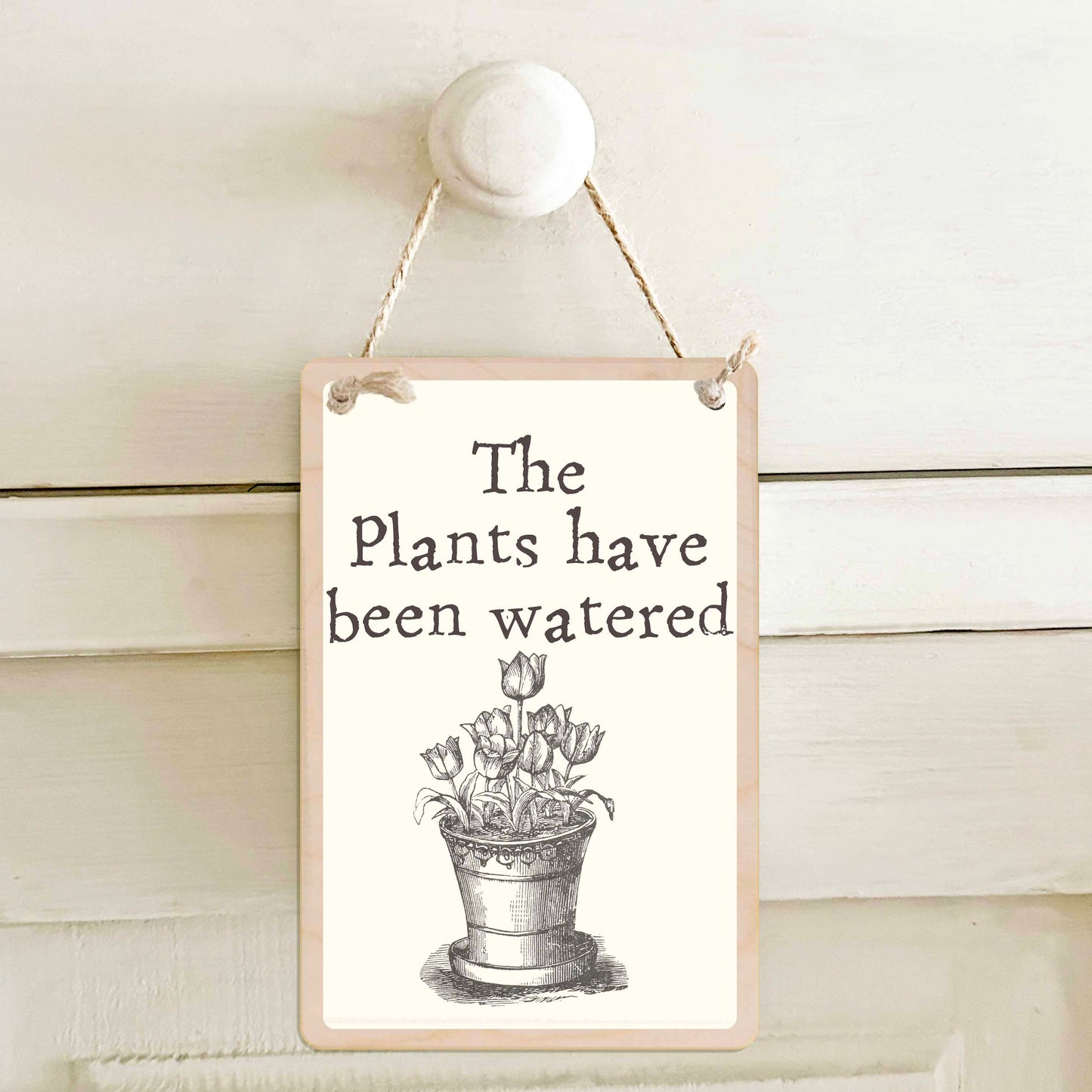 The plants have been watered / The plants have not been watered - Double-sided wooden mini sign.

Made from certified sustainable wood and printed on both sides with a fun, practical message and retro illustration.

15 × 10 cm sustainable wood, natural twine.&nbsp;

Light and durable, eco-friendly, ready to hang.

Made in Suffolk.&nbsp;