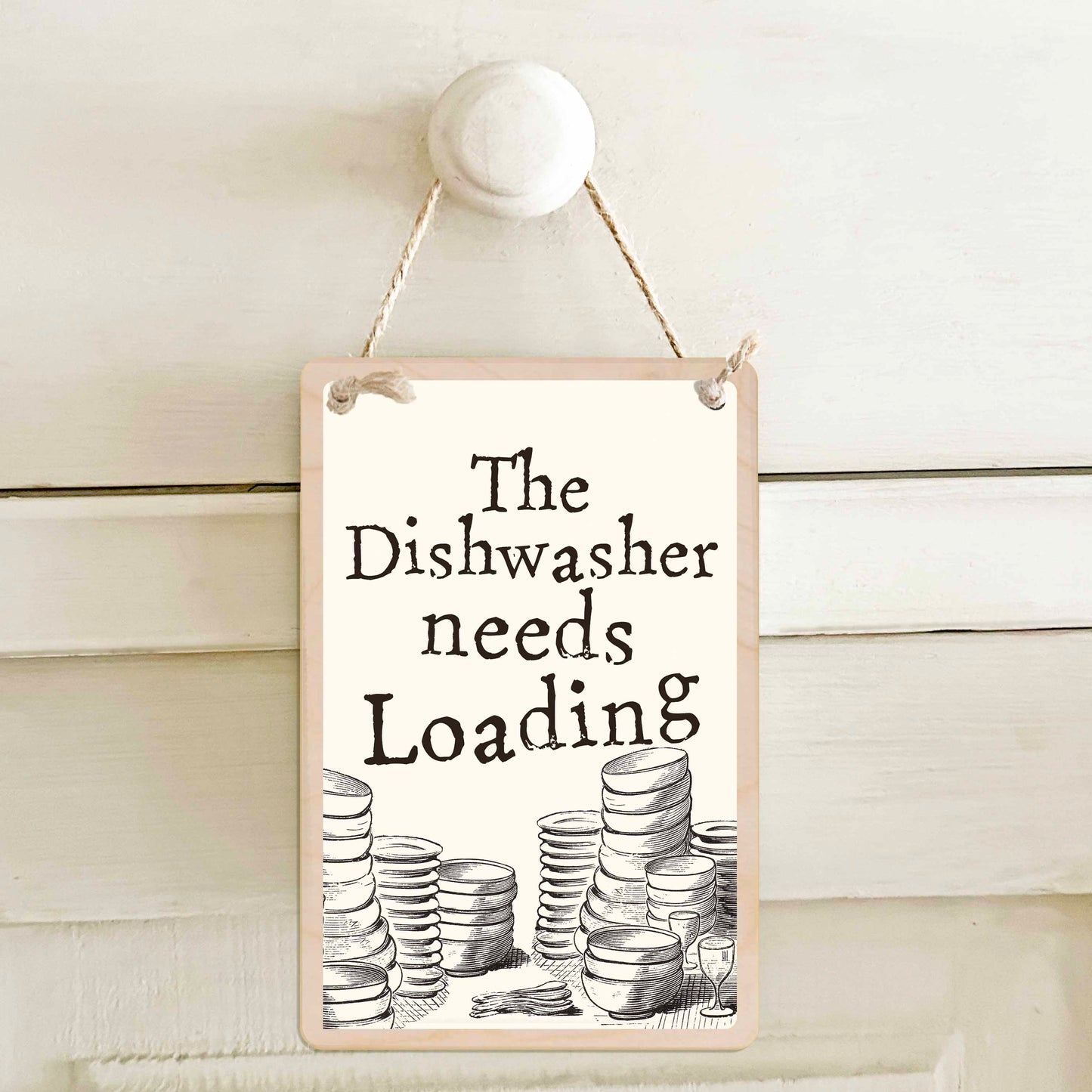 The dishwasher needs emptying / The dishwasher needs loading - Double-sided wooden mini sign.

Made from certified sustainable wood and printed on both sides with a fun, practical message and retro illustration.

15 × 10 cm sustainable wood, natural twine.

Light and durable, eco-friendly, ready to hang.

Made in Suffolk.