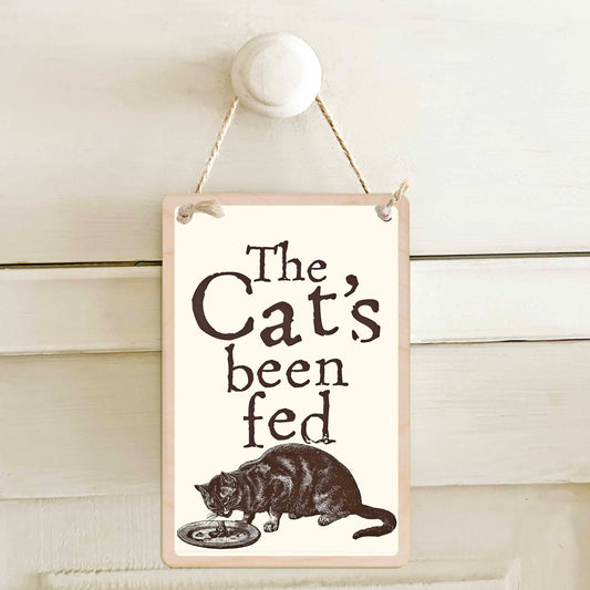 The Cat's been fed / The Cat's not been fed - Double-sided wooden mini sign.

Made from certified sustainable wood and printed on both sides with a fun, practical message and retro illustration.

15 × 10 cm sustainable wood, natural twine.

Light and durable, eco-friendly, ready to hang.

Made in Suffolk.