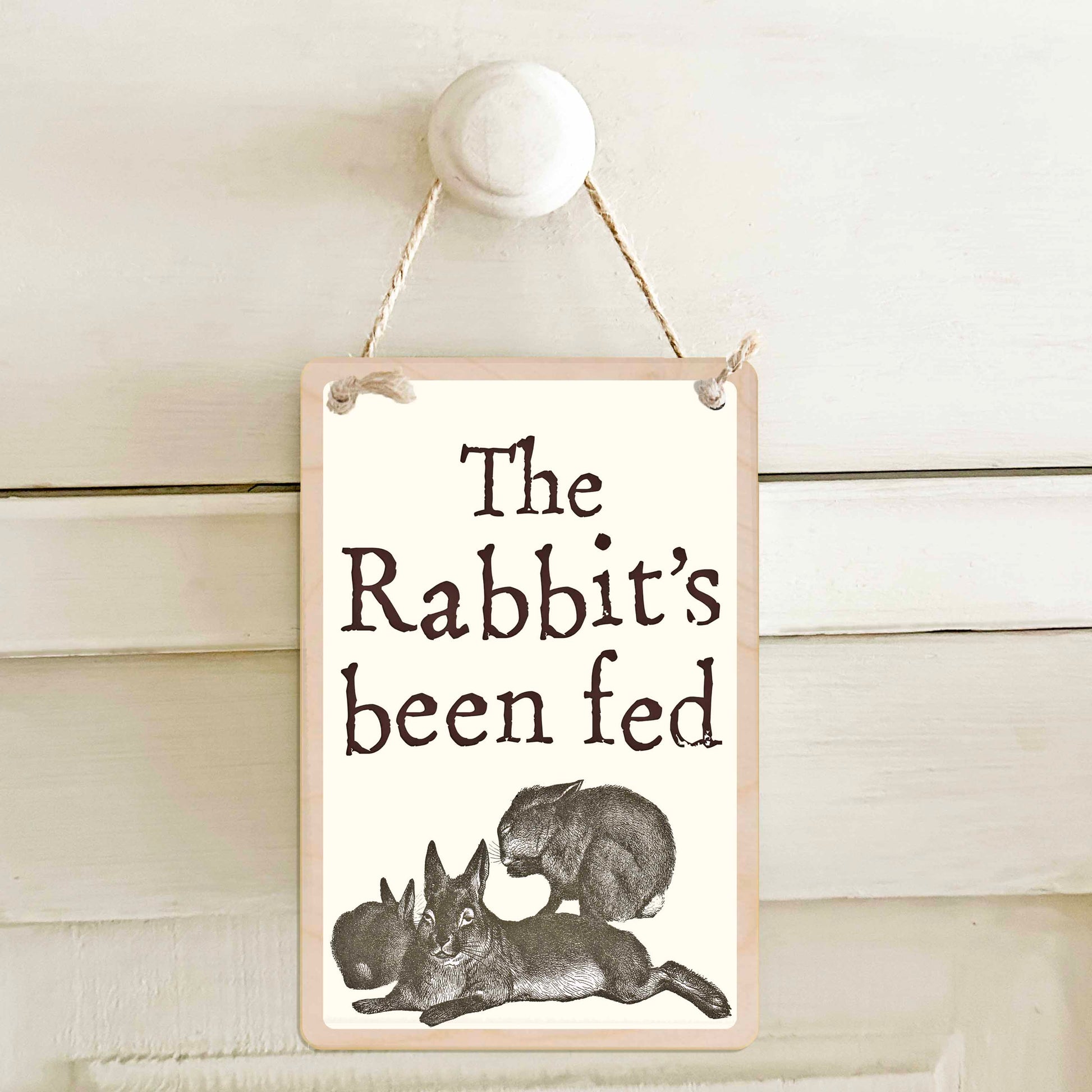 The Rabbit's been fed / The Rabbit's not been fed - Double-sided wooden mini sign.

Made from certified sustainable wood and printed on both sides with a fun, practical message and retro illustration.

15 × 10 cm sustainable wood, natural twine.

Light and durable, eco-friendly, ready to hang.

Made in Suffolk.