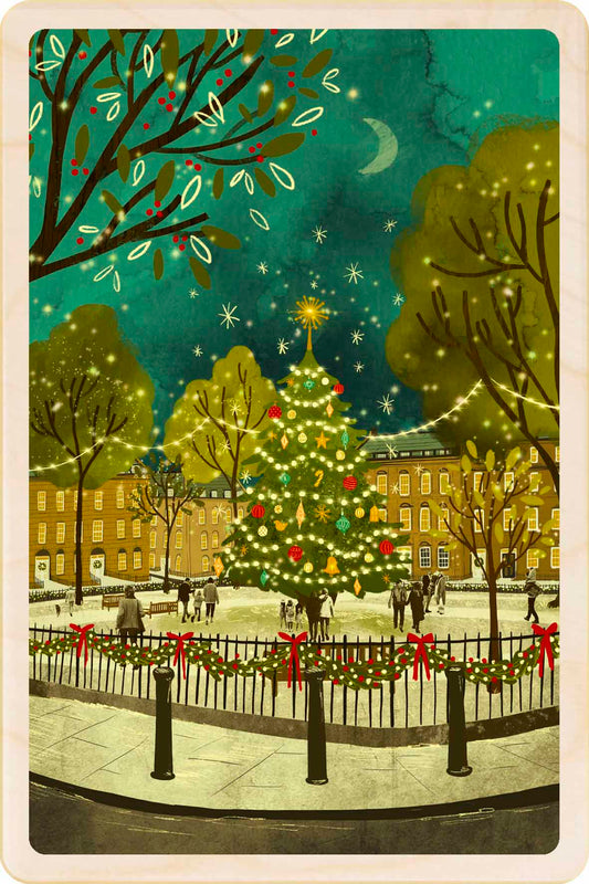 Christmas card with a decorated tree in a snowy town square. Christmas Tree - Christmas Card – Wooden Postcard

Original Christmas illustration ©Emy Lou Holmes, printed on sustainable wood. A beautiful card to send, display, or tuck into a stocking.