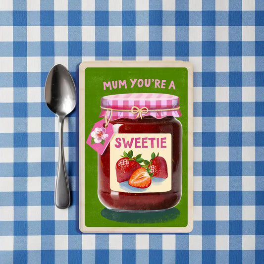 Mother's Day Card: Jar of strawberry jam with a decorative label and ' Mum You're a Sweetie' on a green background - the wooden postcard company
